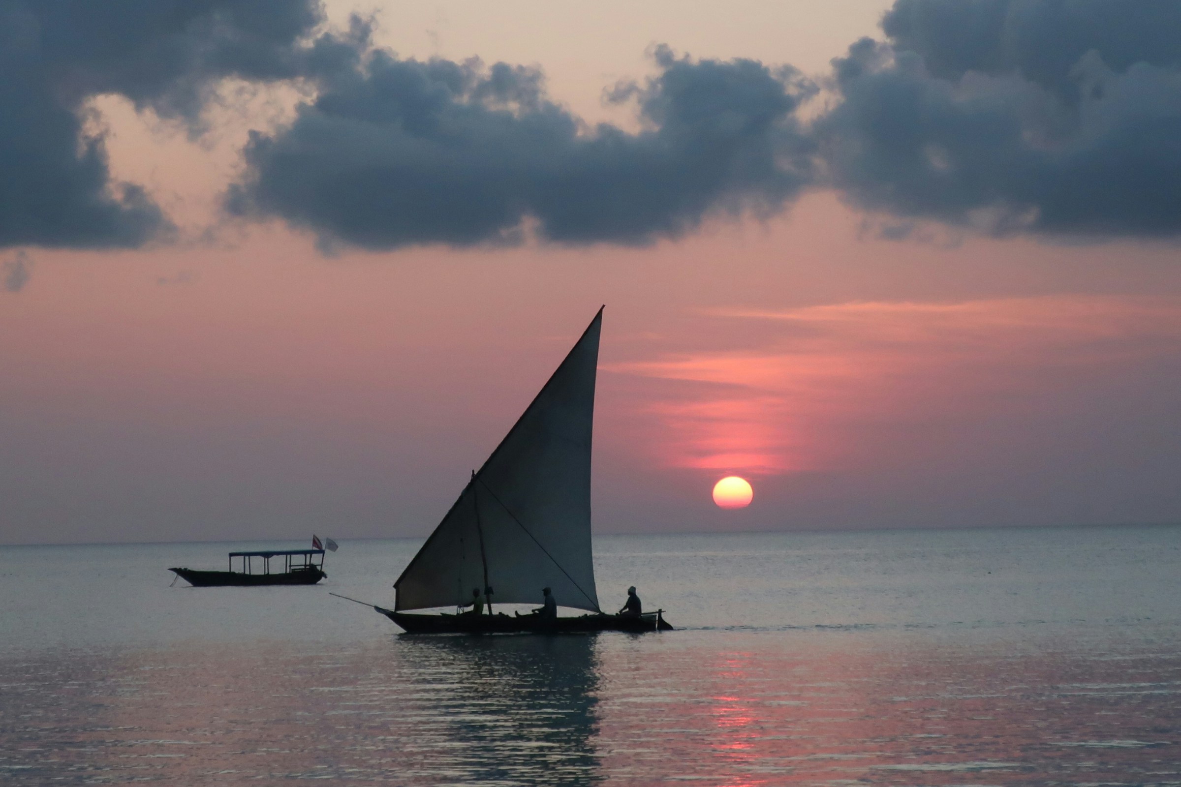 Sailboat sailing into the sunset over the Indian Ocean near Zanzibar on a luxury safari